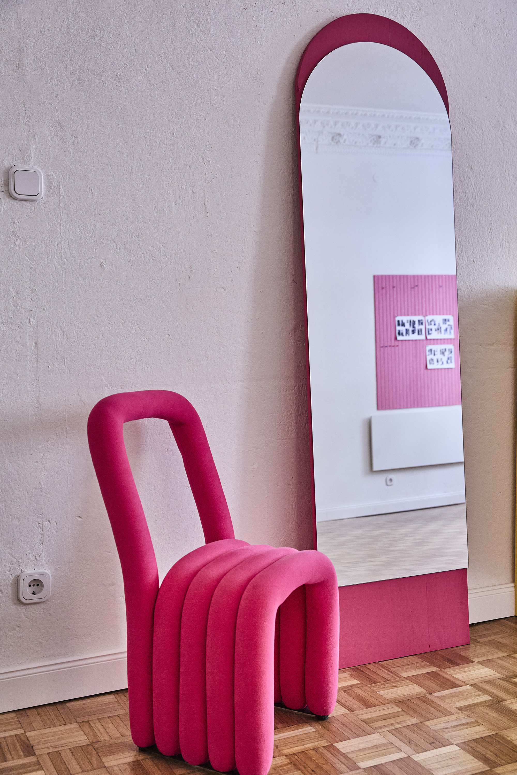 Arched mirror and pink chair in the Fitting Room