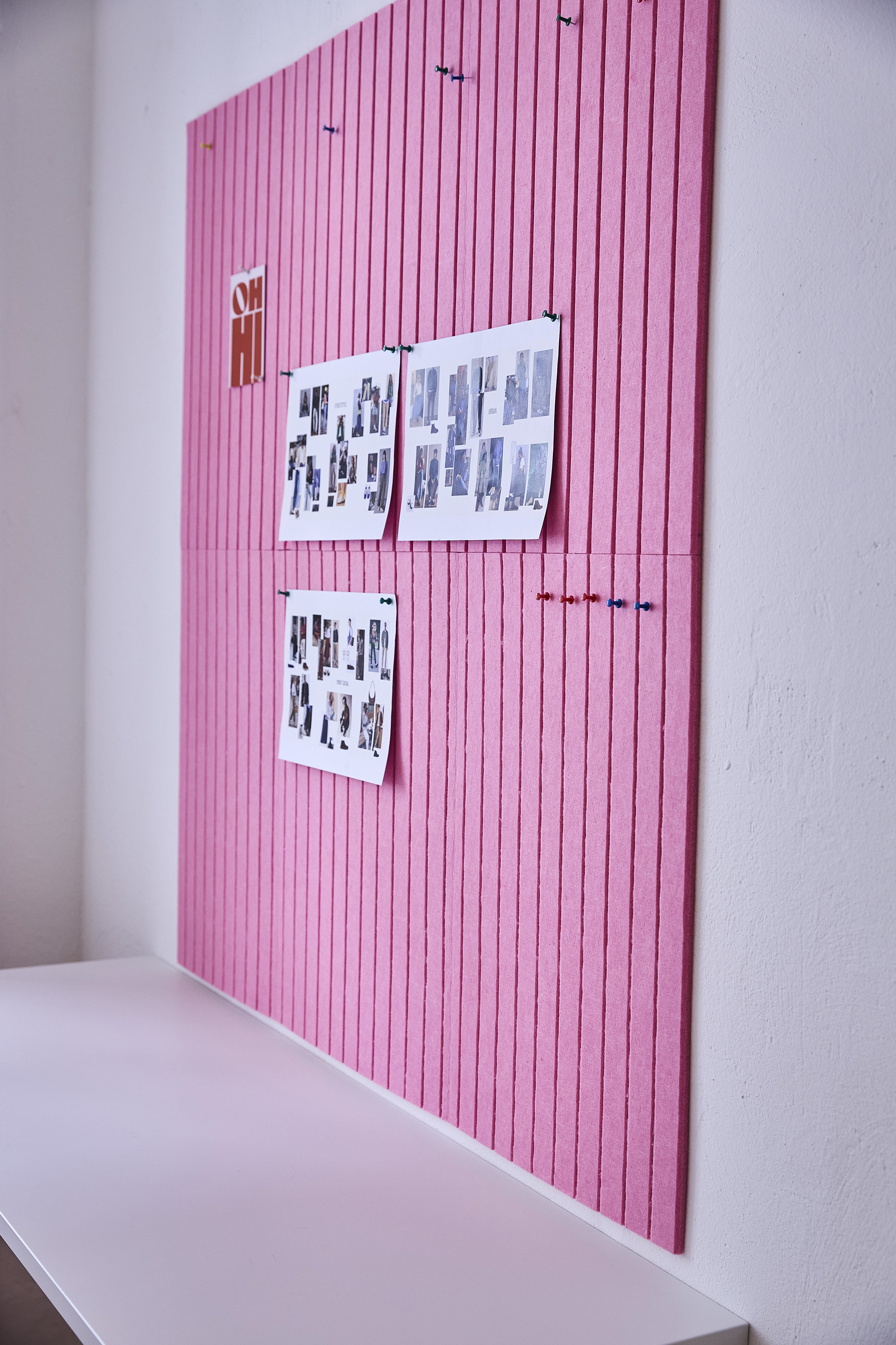 Pink pinboard with mood-board pages pinned up