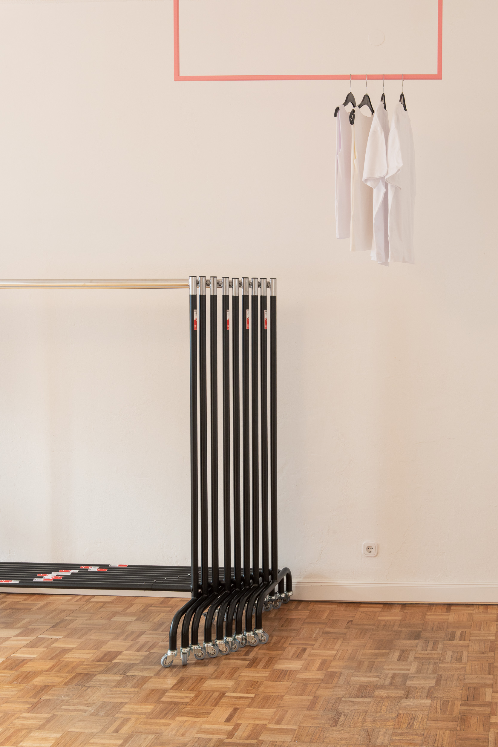 Rack and rail detail — hangers and garments in natural light